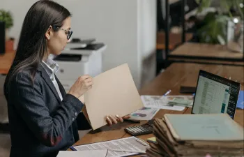 Una empresaria están haciendo leyendo informes en su despacho